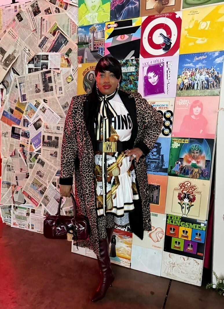 Statement outfit with leopard coat, layered prints, and boots